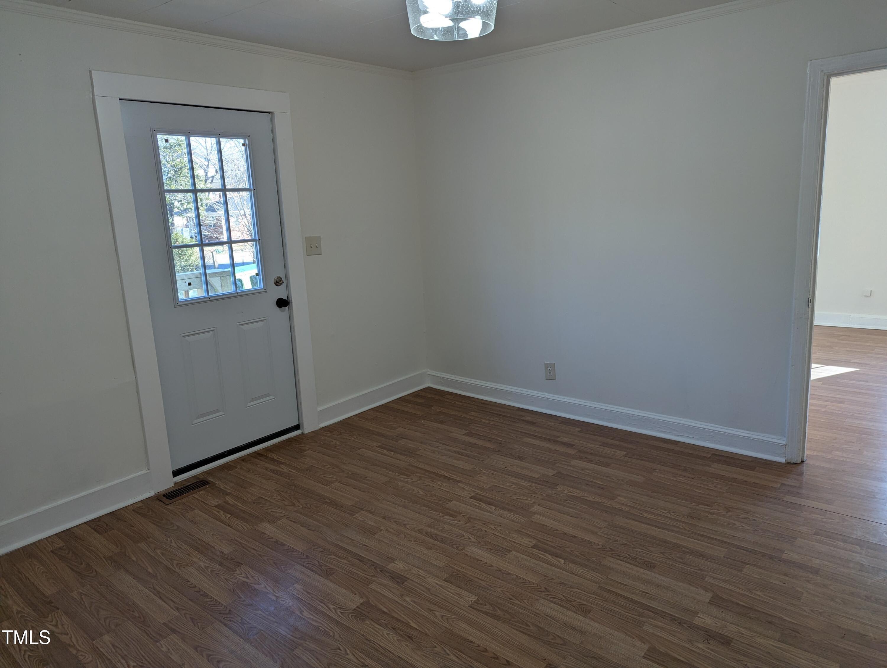 609 North Elizabeth Street, Unit B Durham, NC 27701 - Photo 3 of 11 an empty room with wooden floor and windows