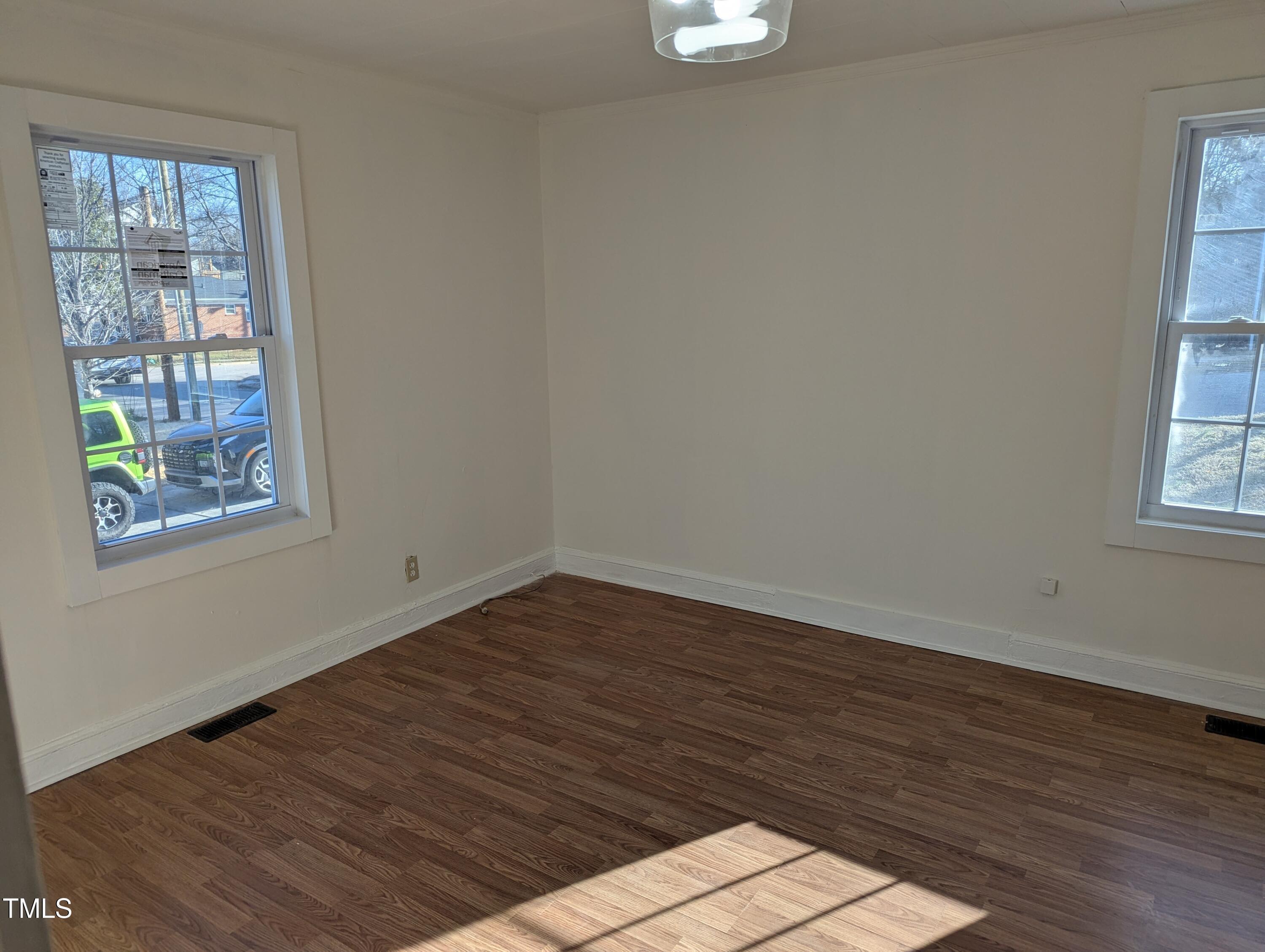 609 North Elizabeth Street, Unit B Durham, NC 27701 - Photo 6 of 11 a view of an empty room with wooden floor and a window