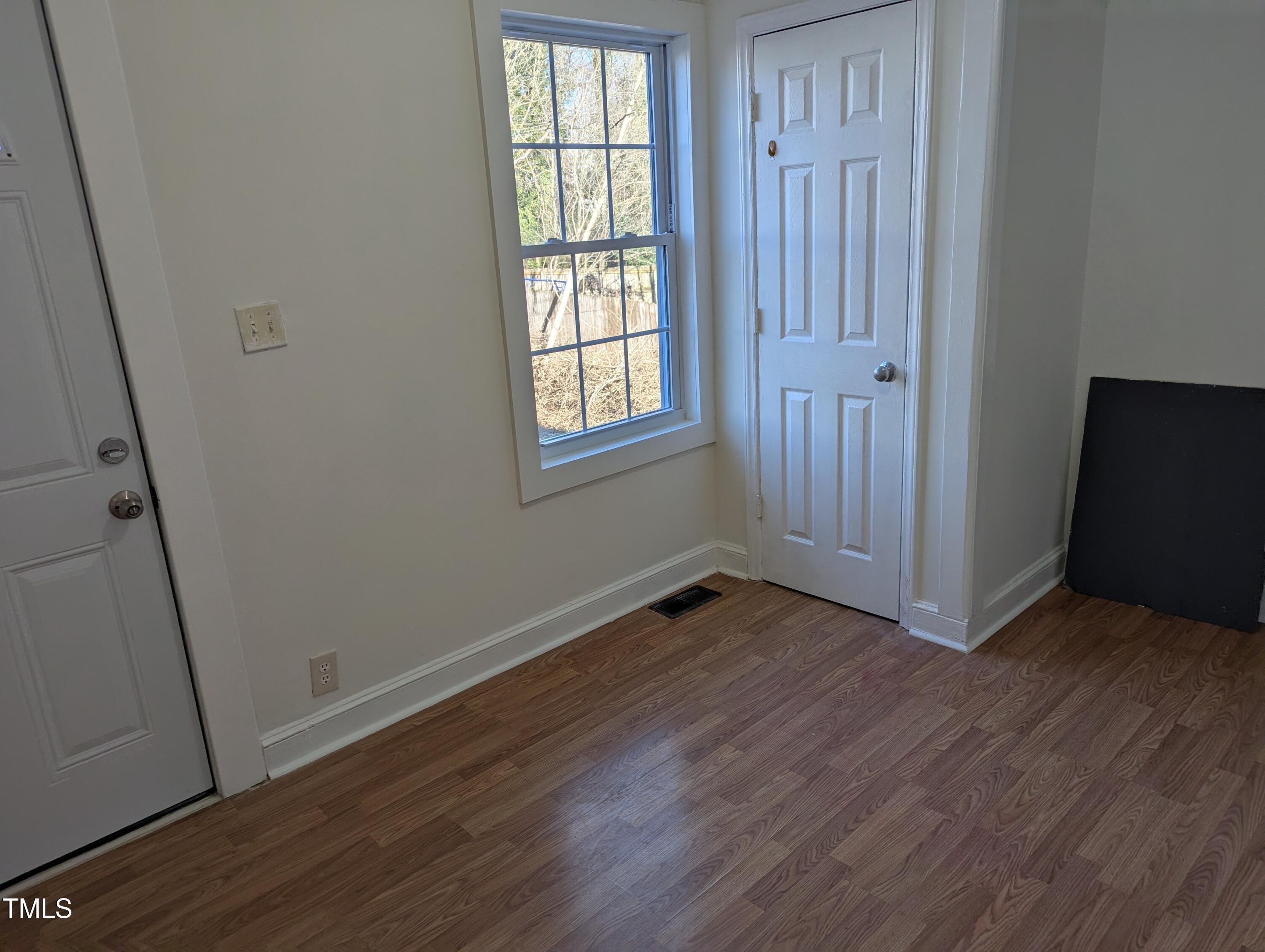 609 North Elizabeth Street, Unit B Durham, NC 27701 - Photo 8 of 11 an empty room with wooden floor and windows