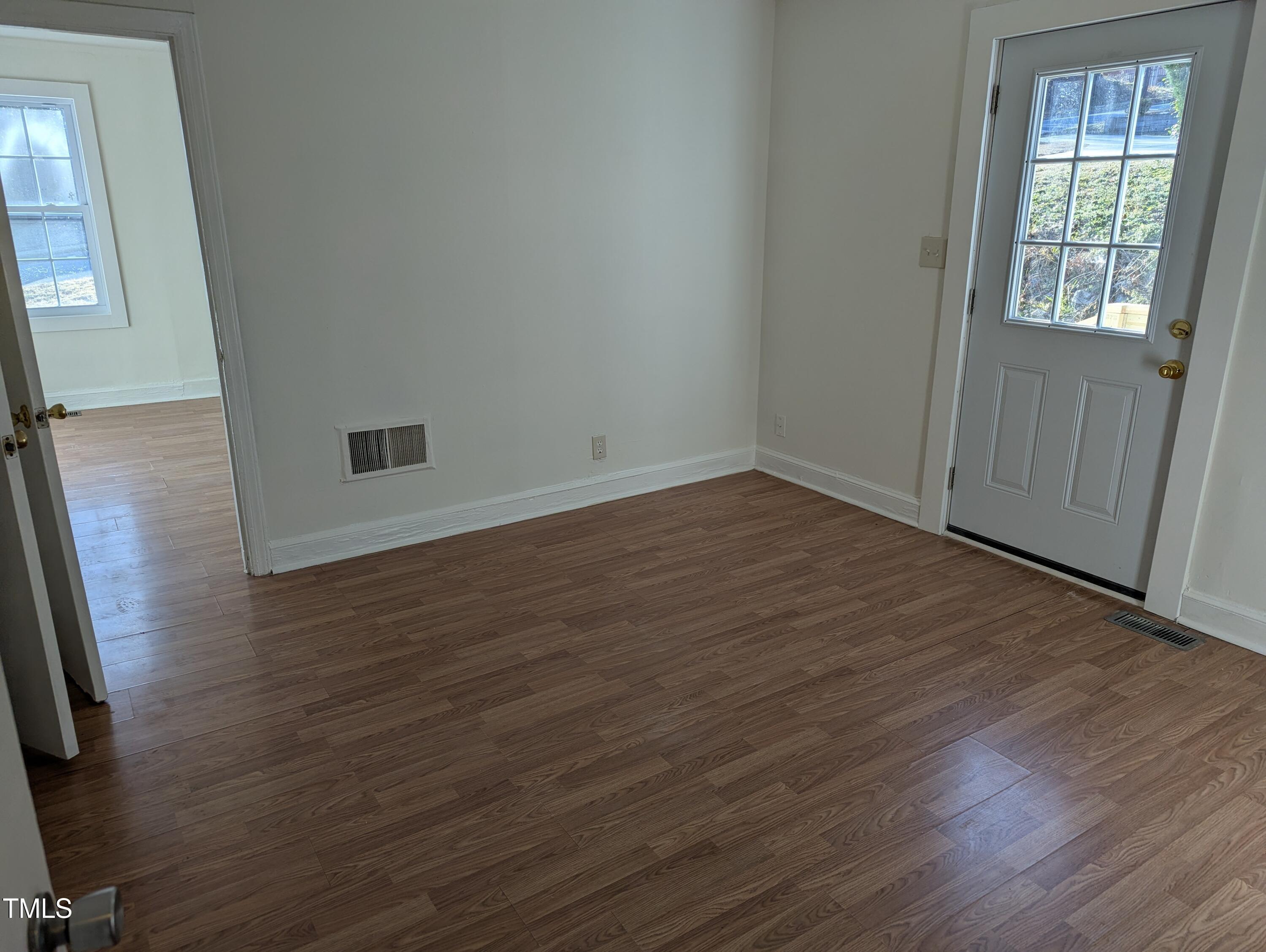 609 North Elizabeth Street, Unit B Durham, NC 27701 - Photo 10 of 11 an empty room with wooden floor and windows