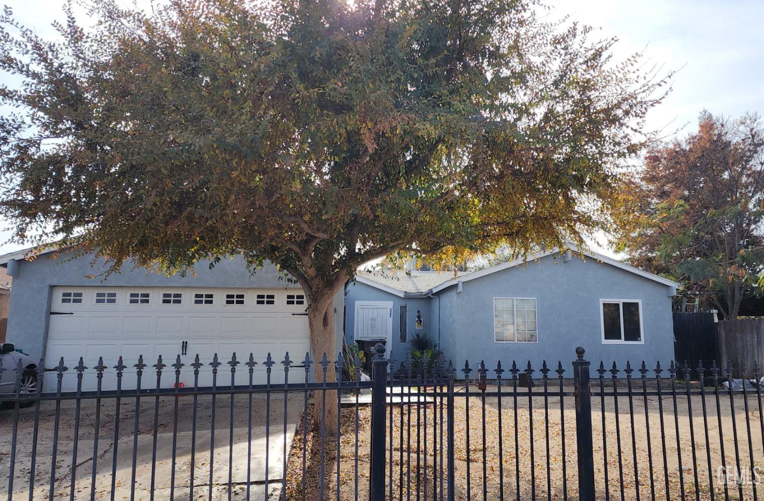 Undisclosed Address Earlimart, CA 93219 - Photo 1 of 3 a front view of a house with a garden