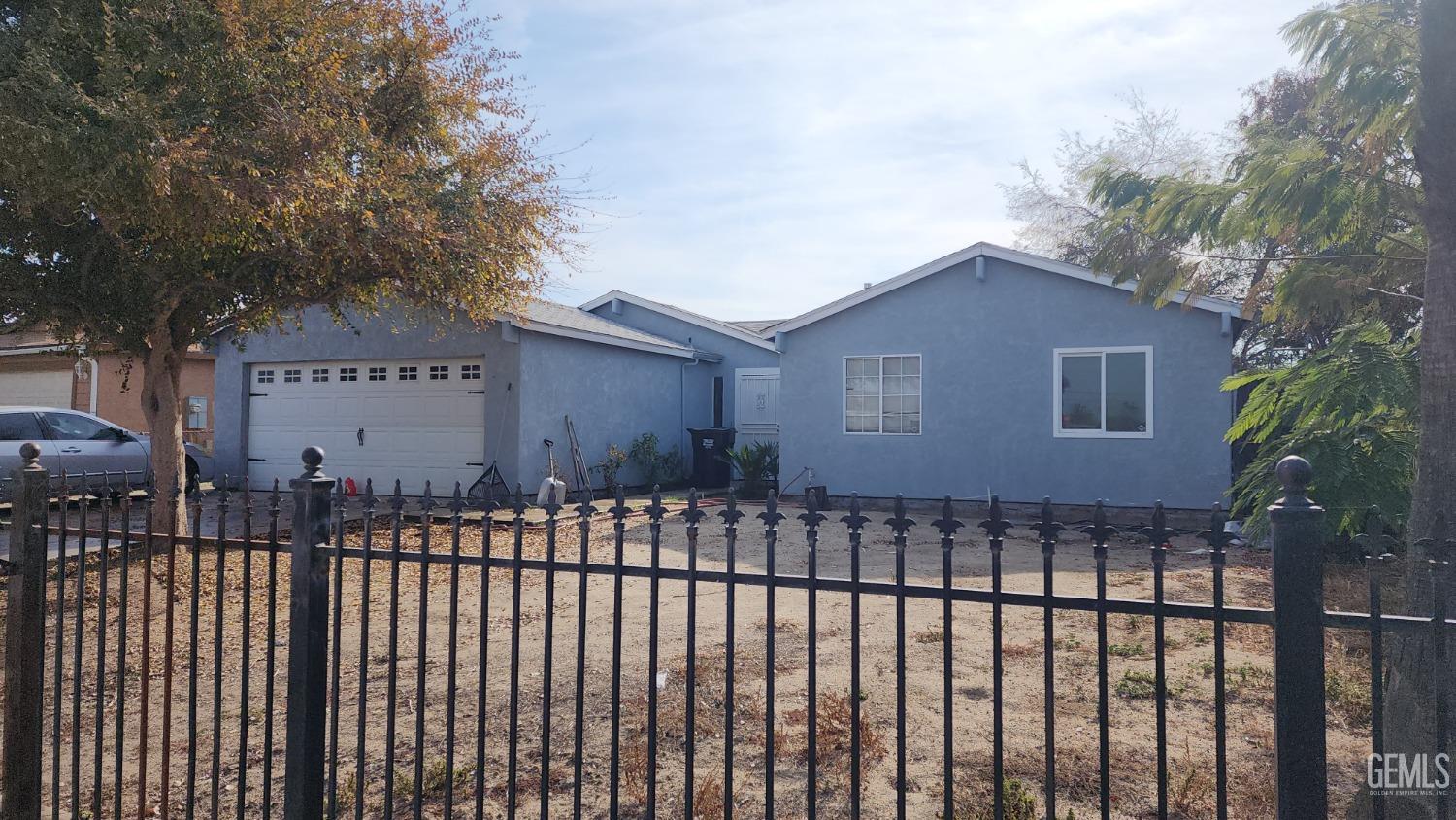 Undisclosed Address Earlimart, CA 93219 - Photo 3 of 3 a front view of a house with a garden