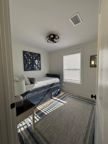 a bedroom with furniture and a window