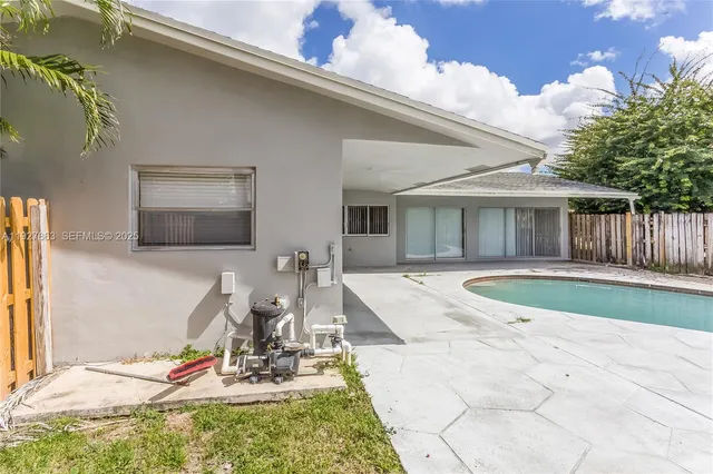a view of a house with backyard sitting area and garden