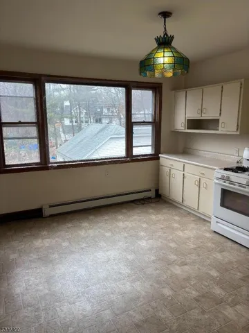 a view of a kitchen with a stove cabinets and a large window