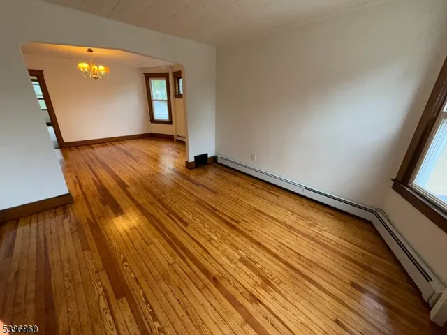 a view of an empty room and wooden floor
