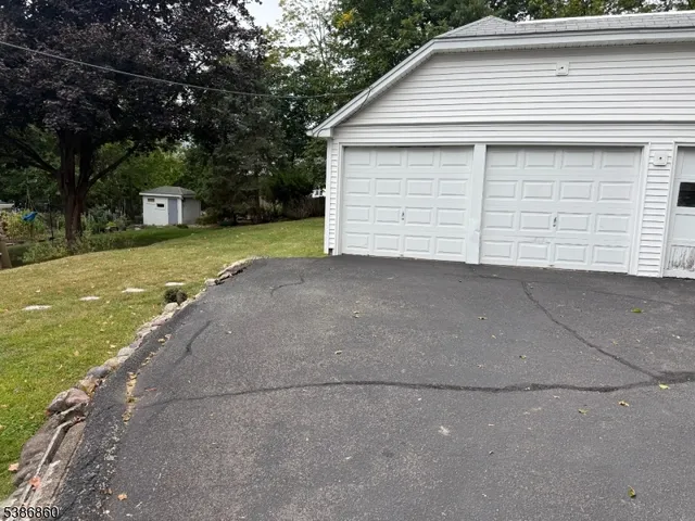 a view of a house with a yard and garage