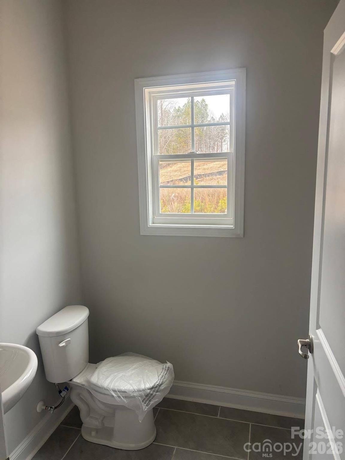 1590 Autumn Place, Unit 116 York, SC 29745 - Photo 13 of 28 a white toilet sitting next to a window in a bathroom