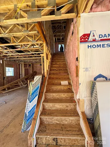 a view of a room with wooden floor and windows