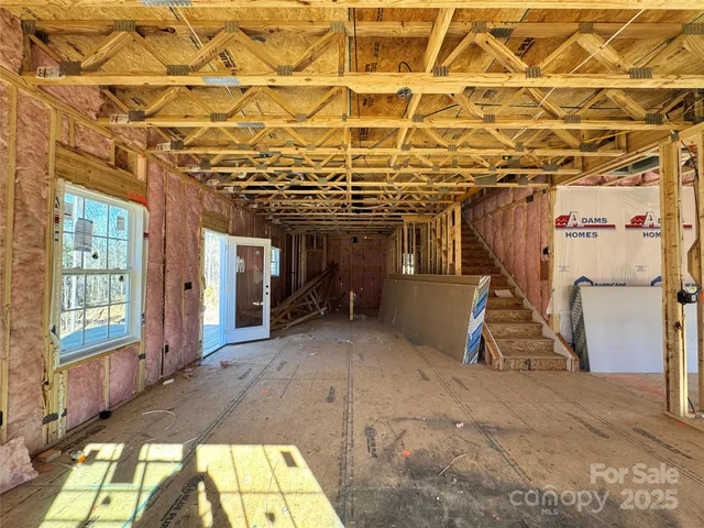 a view of a room with wooden floor and stairs