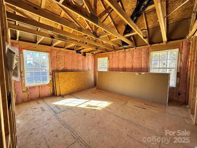a view of walk in closet with wooden floor