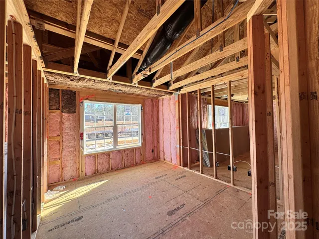 a view of a house with wooden fence