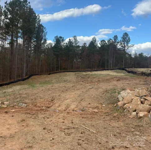 a view of wooden fence and trees