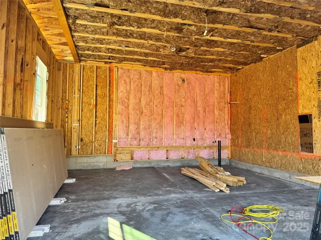 a view of a room with wooden floor and a window
