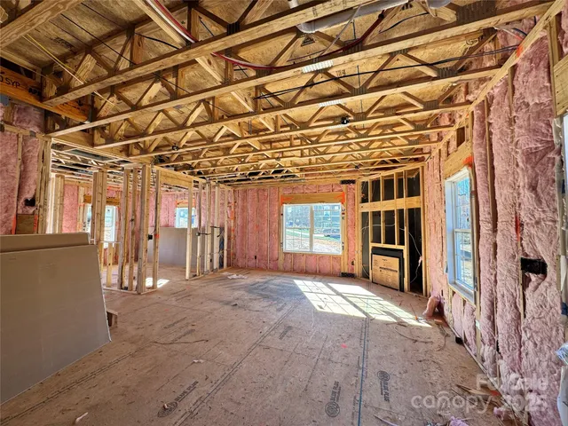 a view of a room with wooden floor and windows