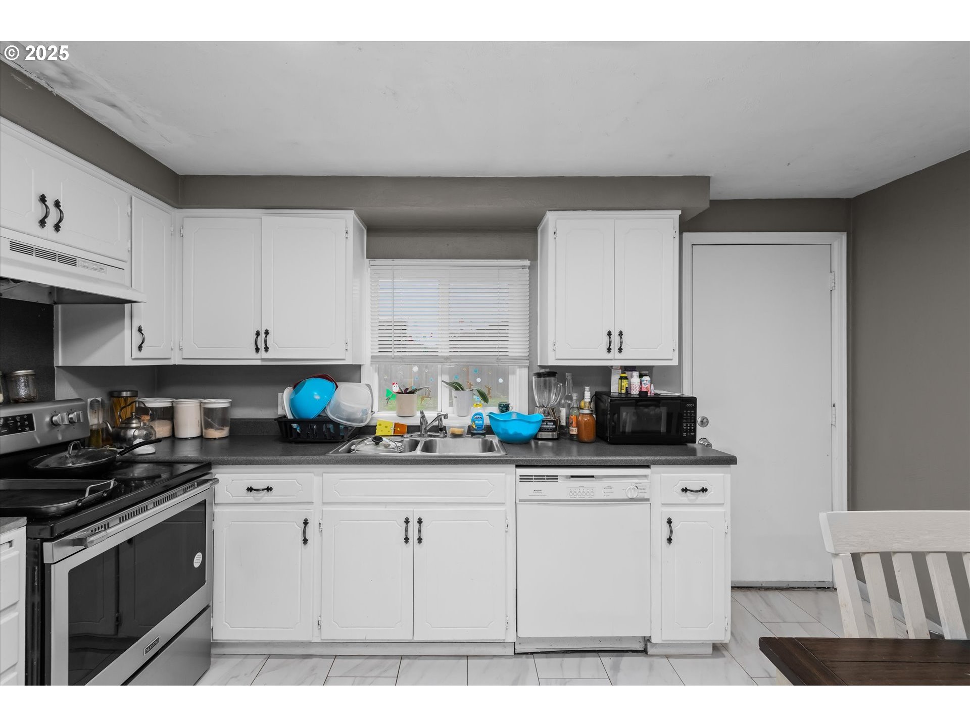 465 25th Street Springfield, OR 97477 - Photo 9 of 32 a kitchen with stainless steel appliances a sink a stove a microwave a counter top space and cabinets