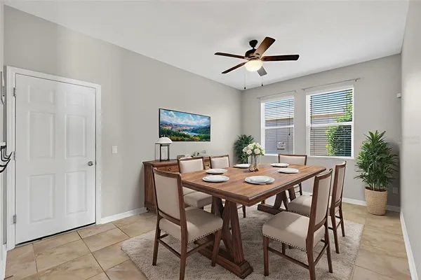 a dining room with furniture and window