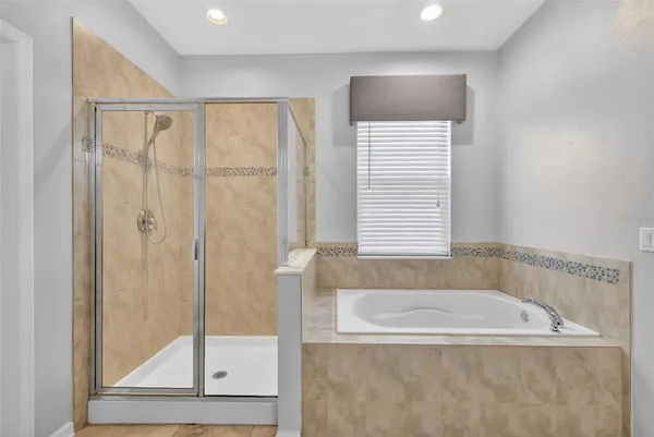 a white bath tub sitting next to a shower