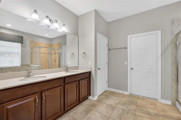 a bathroom with a double vanity sink and a mirror
