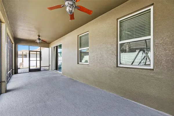 a view of a livingroom with a ceiling fan and window