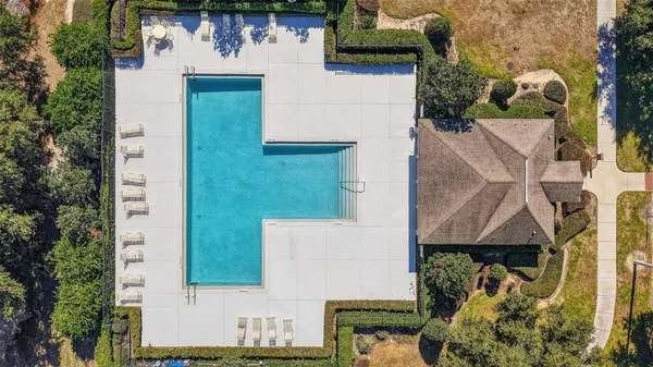 an aerial view of a house with a yard basket ball court and outdoor seating