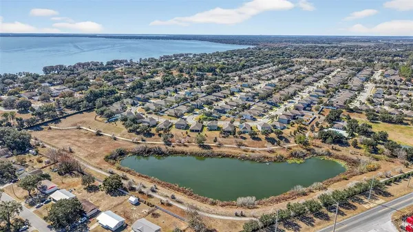 an aerial view of a house with a yard