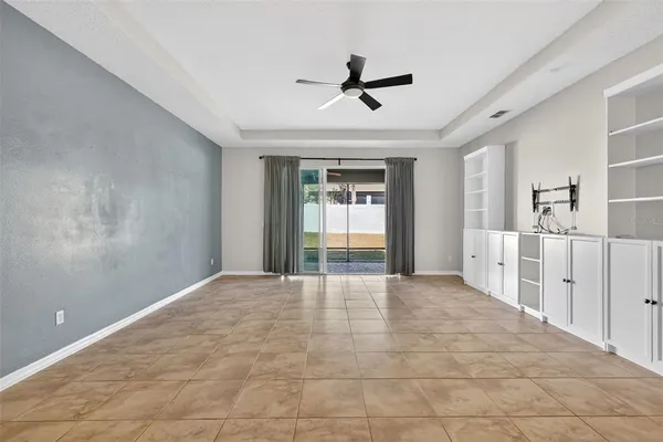 a view of a livingroom with a ceiling fan and window
