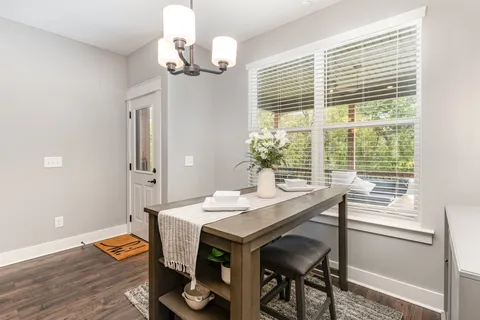 a view of a dining room with furniture wooden floor and chandelier