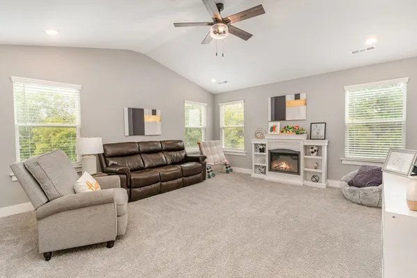 a living room with furniture and a fireplace