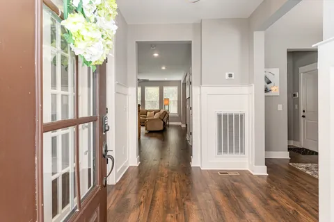 a view of a hallway view with wooden floor and staircase