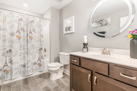 a view of bathroom with a toilet sink and mirror
