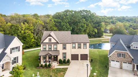 an aerial view of a house with a yard