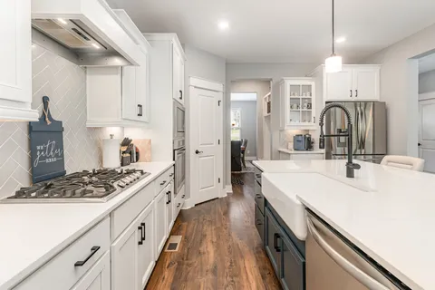 a kitchen with kitchen island a sink stove and refrigerator