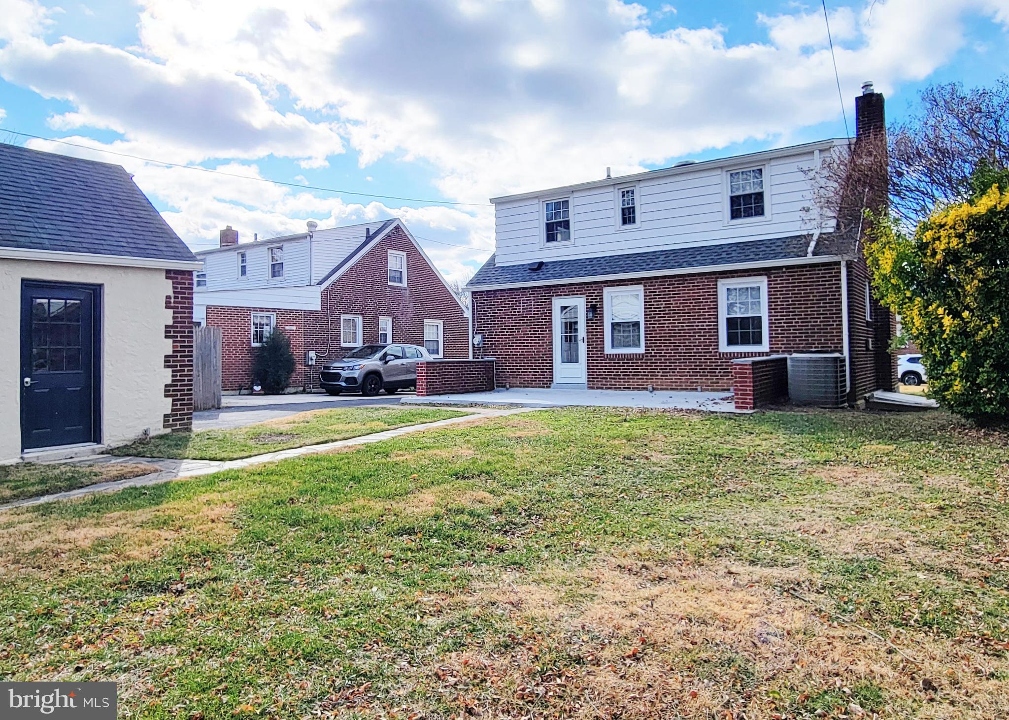 409 Perry Street Ridley Park, PA 19078 - Photo 24 of 66 Charming brick homes under a bright sky.
