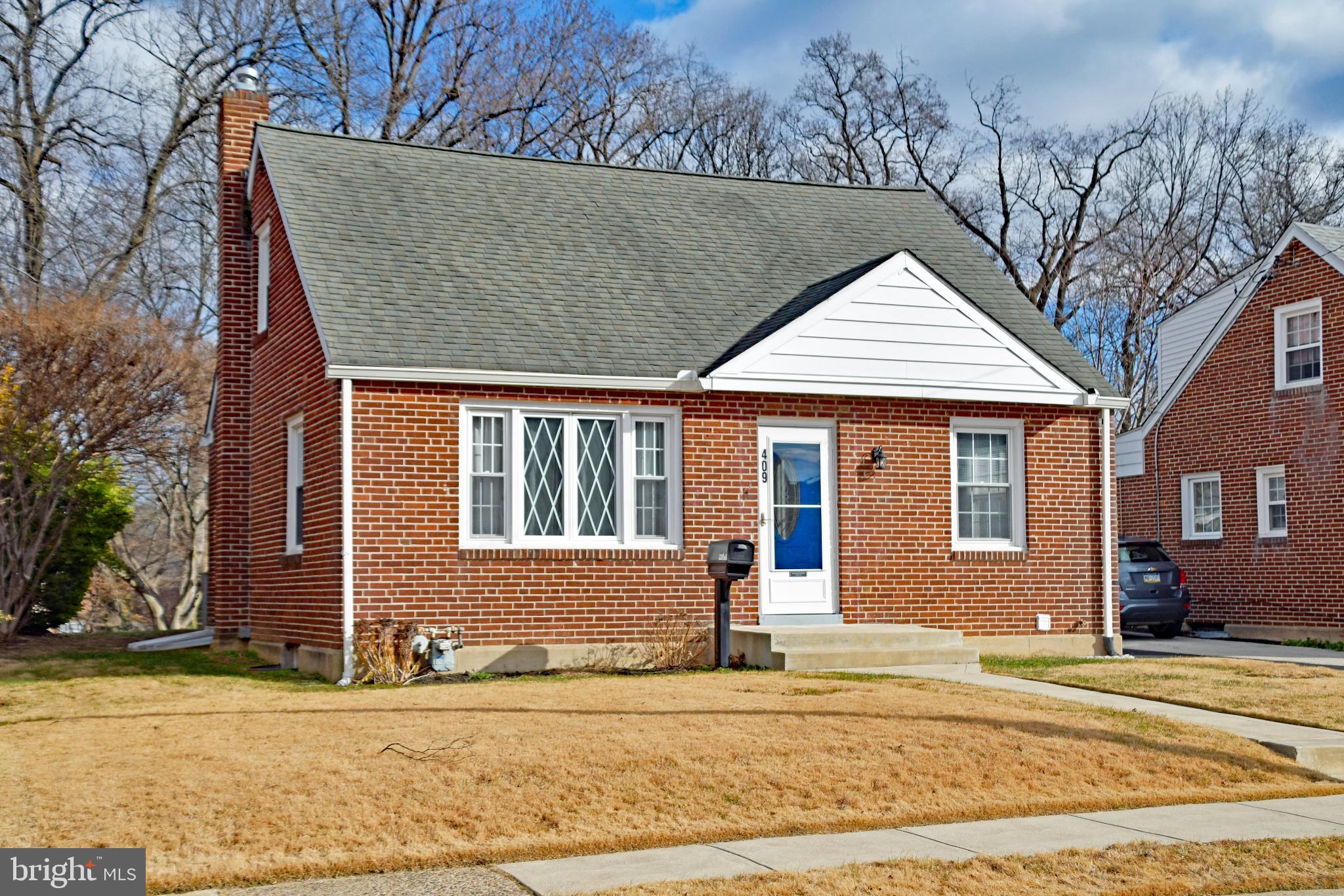 409 Perry Street Ridley Park, PA 19078 - Photo 3 of 66 a front view of a house with a garden and tree