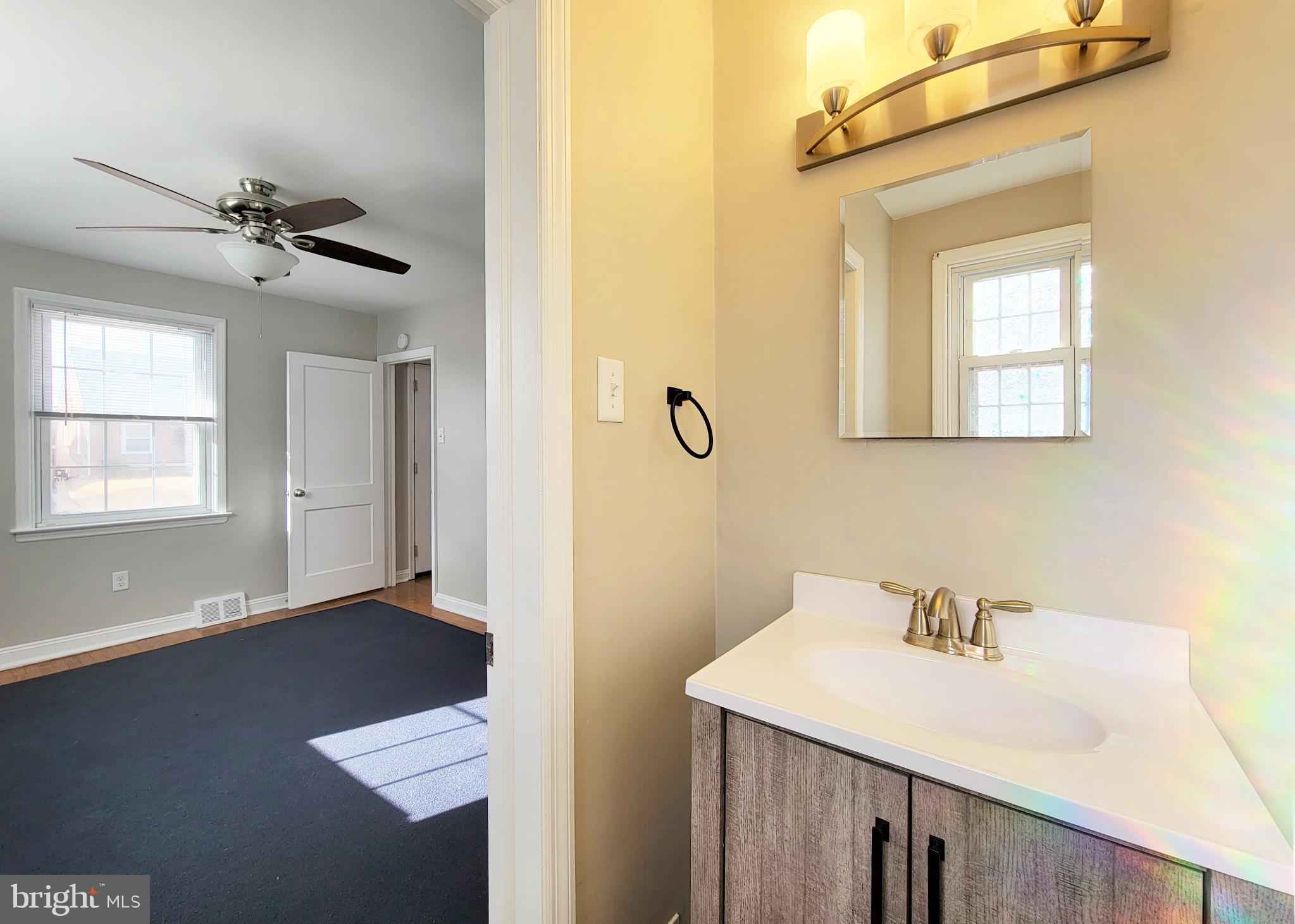 409 Perry Street Ridley Park, PA 19078 - Photo 36 of 66 a bathroom with a sink a mirror and a vanity