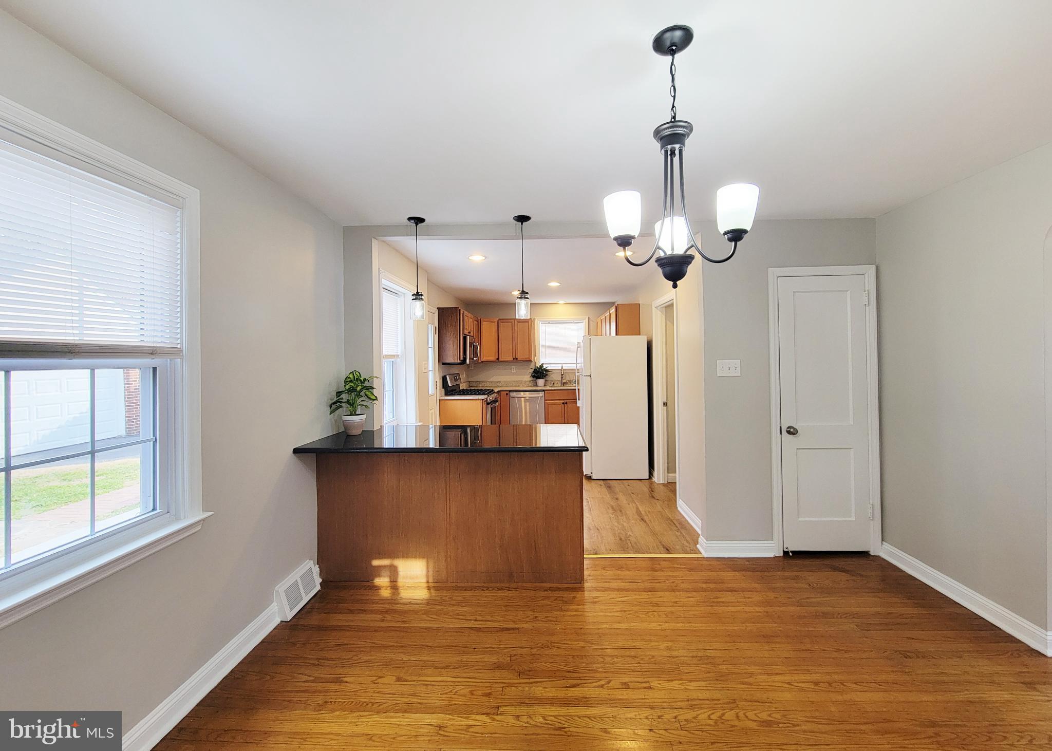 409 Perry Street Ridley Park, PA 19078 - Photo 40 of 66 a view of a kitchen with granite countertop cabinets and a wooden floor