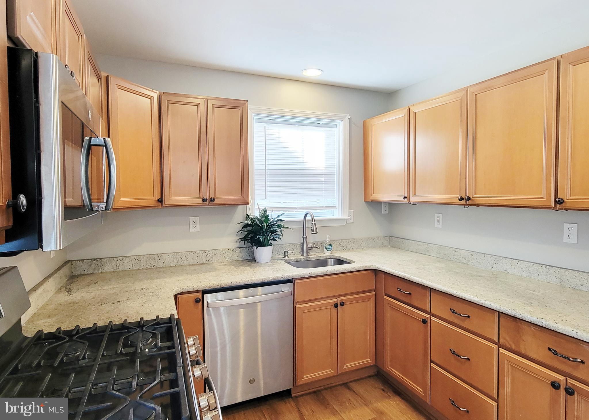 409 Perry Street Ridley Park, PA 19078 - Photo 43 of 66 a kitchen with stainless steel appliances granite countertop a sink a stove and cabinets