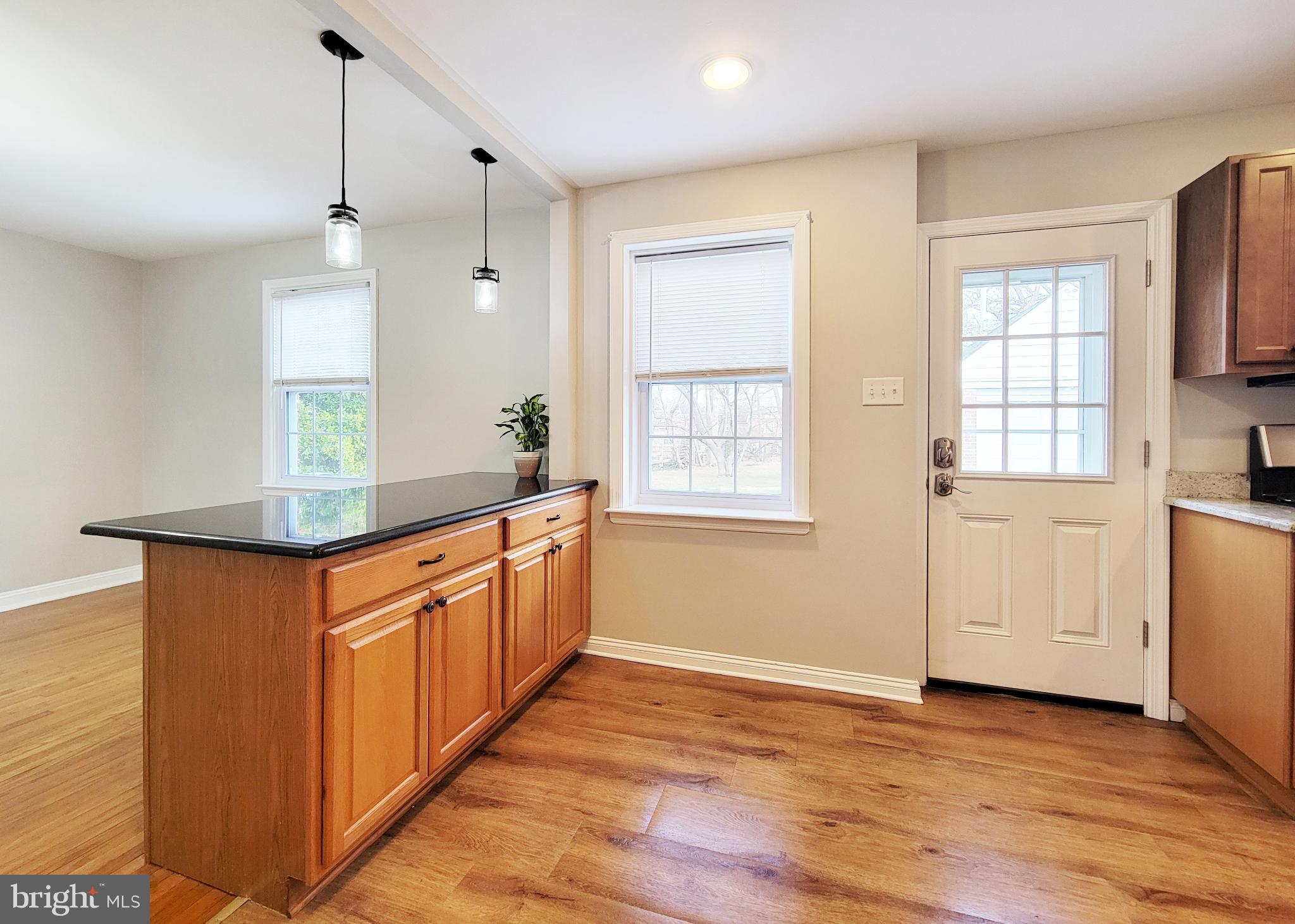 409 Perry Street Ridley Park, PA 19078 - Photo 46 of 66 a kitchen with stainless steel appliances granite countertop a sink stove and wooden cabinets