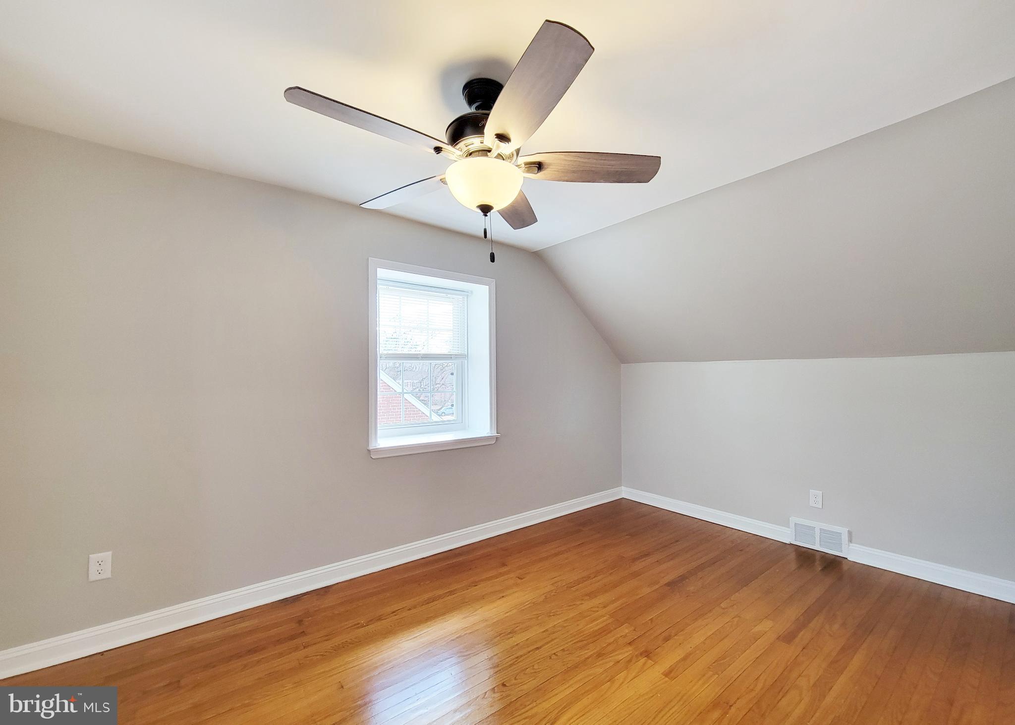 409 Perry Street Ridley Park, PA 19078 - Photo 57 of 66 an empty room with wooden floor fan and windows