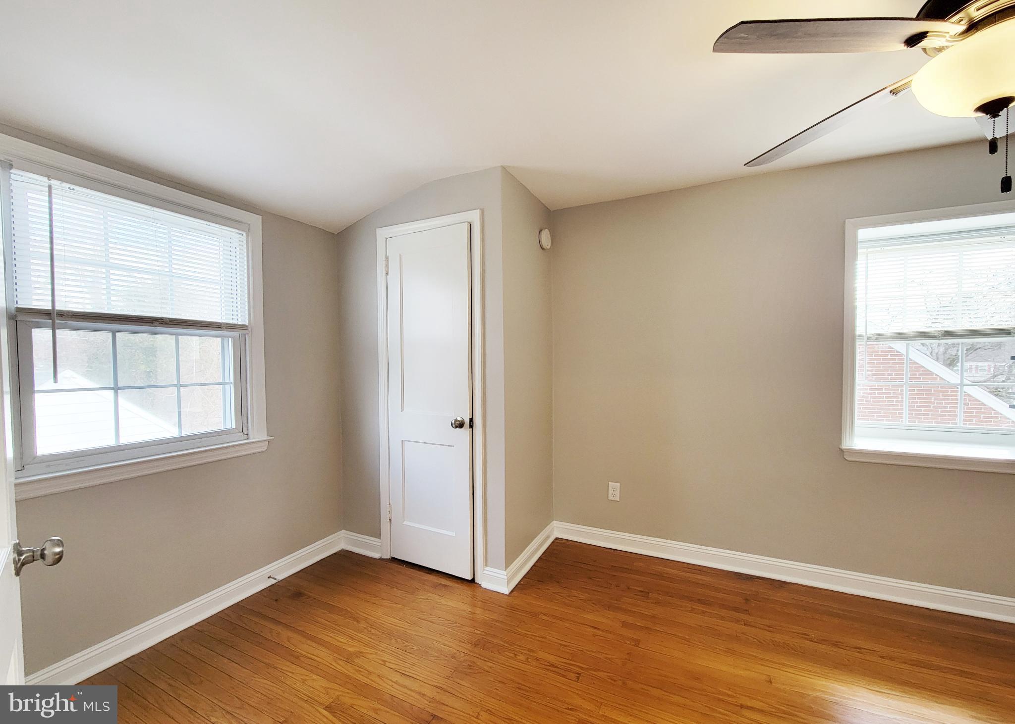 409 Perry Street Ridley Park, PA 19078 - Photo 58 of 66 an empty room with wooden floor and windows