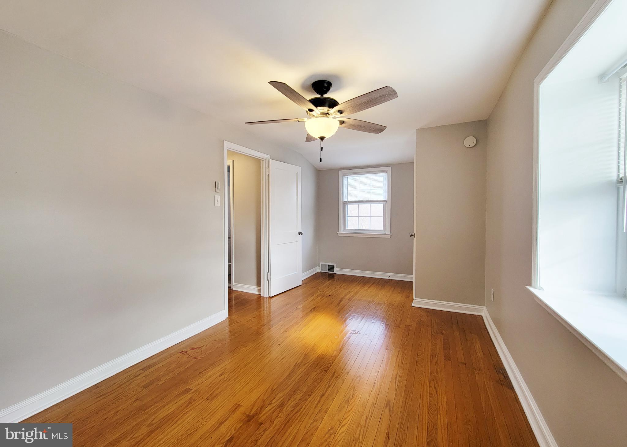 409 Perry Street Ridley Park, PA 19078 - Photo 59 of 66 an empty room with wooden floor and windows