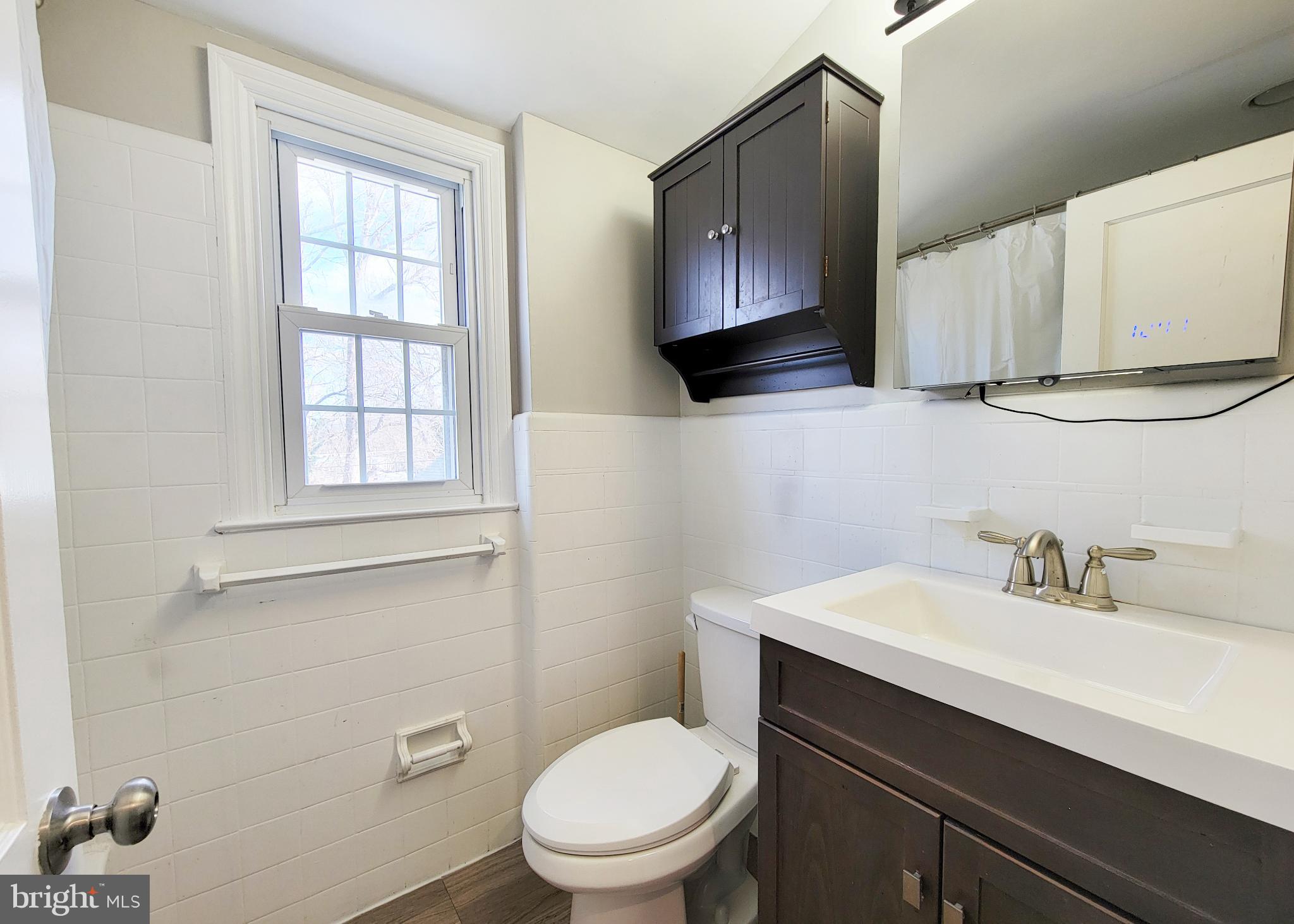 409 Perry Street Ridley Park, PA 19078 - Photo 60 of 66 a bathroom with a sink a toilet and mirror