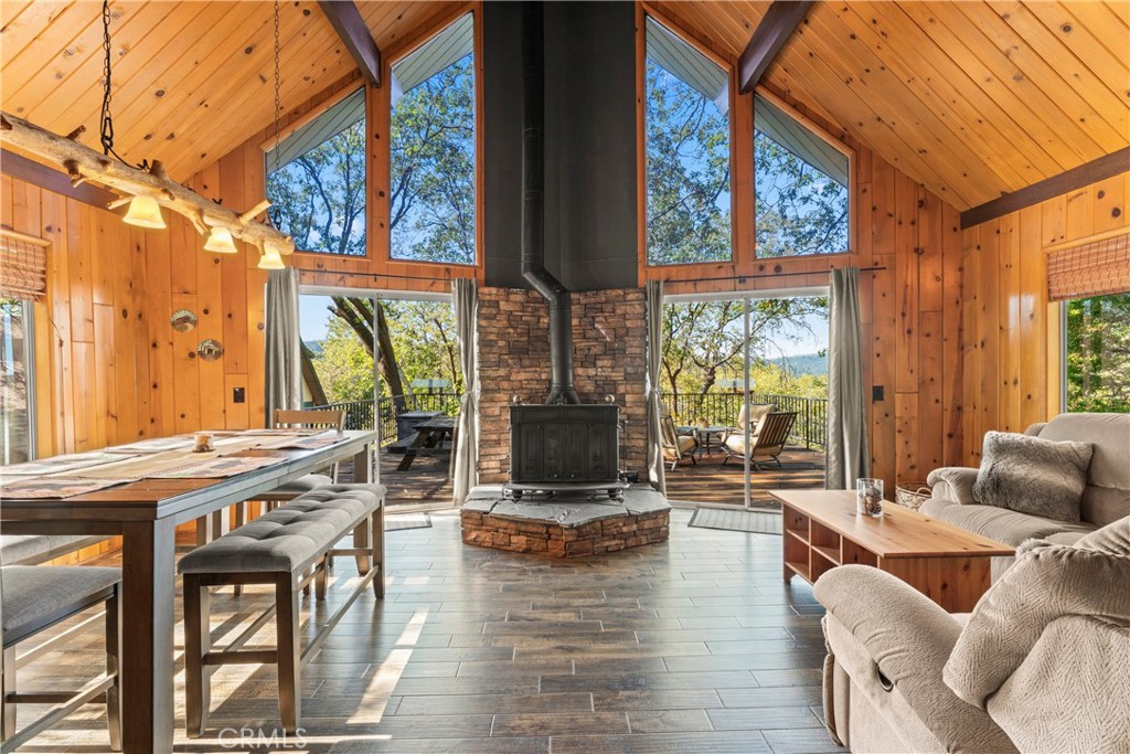 a living room with fireplace furniture and a large window