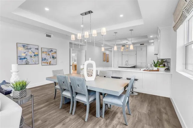 a view of a dining room with furniture wooden floor and chandelier