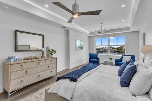 a bedroom with a bed and ceiling fan