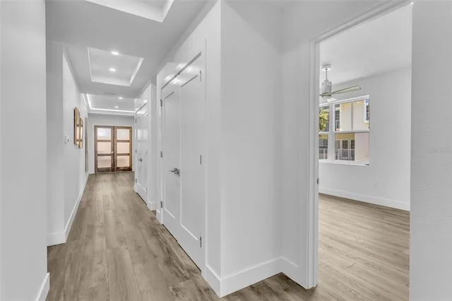 a view of hallway with wooden floor