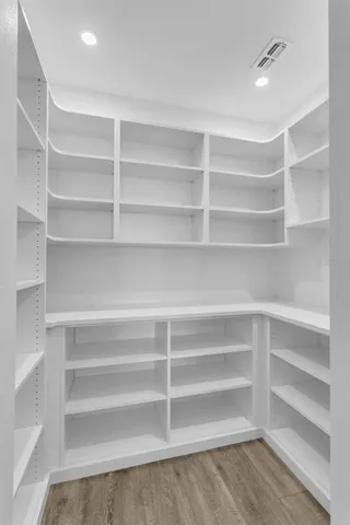 a view of walk in closet with empty racks