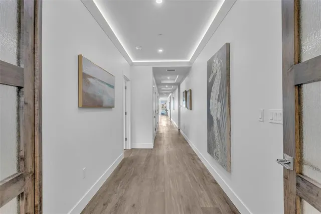 a view of a hallway with wooden floor