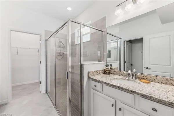 a bathroom with a granite countertop sink mirror and double